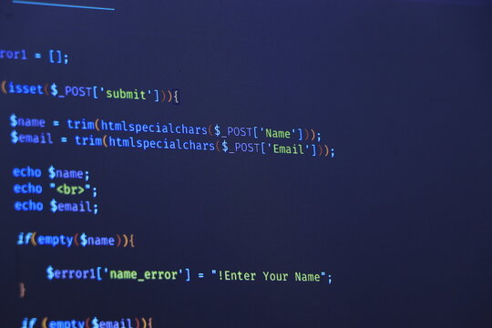 Programmer coding python, java script, html code on notebook screen at home. Work from home.