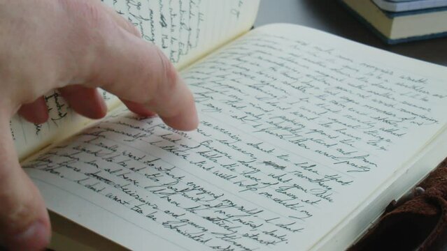 Flipping through handwritten notebook or journal to a blank page