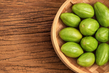 Terminalia chebula fruits on wooden background.