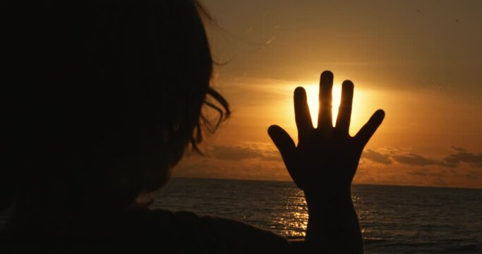little boy kid catching sun glare with fingers hand, child silhouette enjoy family trip to ocean childhood dreams and memories concept, happy kid at sunset,human hand, child dream, tranquil scene