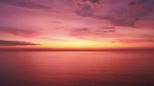 Aerial view hyperlapse of Majestic sunset or sunrise landscape, Amazing light of nature cloudscape sky and Cloud over sea moving away rolling colorful dark sunset cloud Footage timelapse Beautiful sky