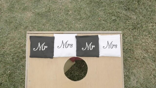 Mr. and Mrs. cornhole game for outdoors backyard wedding. Outdoor wedding ideas. Shot in 4K 60FPS for high quality slow motion. Purchase entire event raw at wholesale price willneatheryyahoo.com.