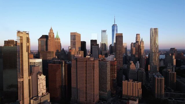 Aerial view around the financial district of Manhattan, golden hour in New York, USA - circling, drone shot