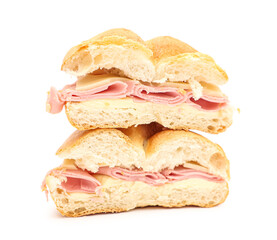 Halves of delicious kaiser roll with ham and cheese on white background