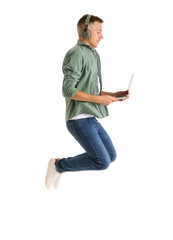 Young man with headphones and laptop jumping on white background. Online education