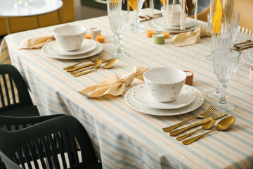 Stylish dinnerware on served table