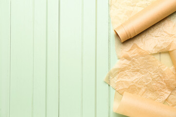 Baking paper on green wooden background