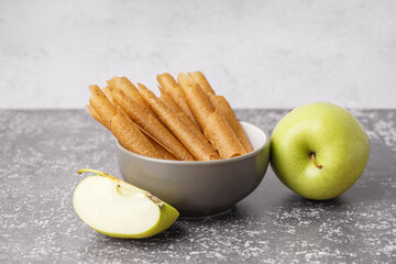 Bowl of tasty apple pastilles on table