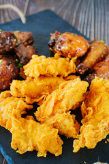 caramelized chicken with sesame and garlic, meat strips in breadin.