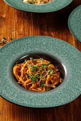 Close up view of pasta with minced meat on wooden table