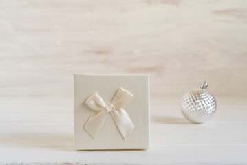 Gift box for Winter holidays, Christmas, New Year on white wooden background.