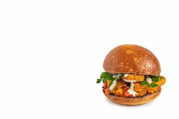 Kosher burger with chicken schnitzel, tahini sauce, fresh parsley on white background. Free space for text.