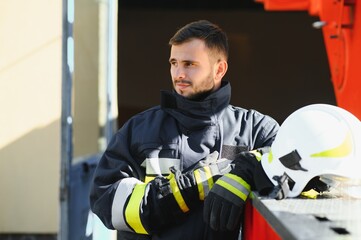 Photo of fireman with gas mask and helmet near fire engine