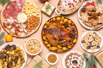 Christmas table setting with tasty food and gifts on beige background