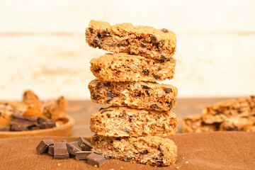 Tasty biscotti cookies and chocolate on brown napkin near light wall