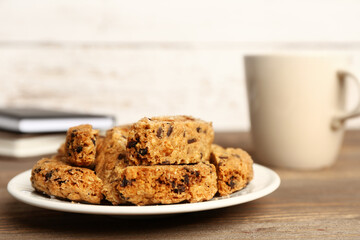 Plate with tasty biscotti cookies on wooden table