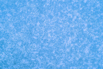 Pure blue ice in a luminous pattern of beautiful frost veins. Background concept