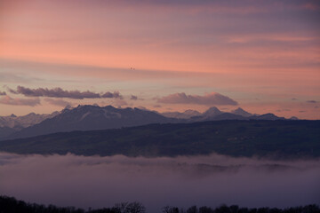 Dramatic sunrise over the mountains, Swiss Alps with mount Pilatus, Eiger and Jungfrau with purple sky, Switzerland
