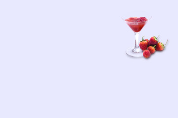 Isolated image of strawberry juice in glass of champagne on light purple background.