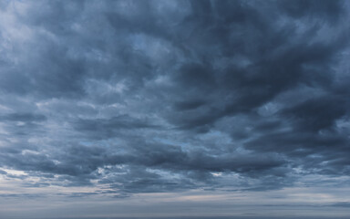 Naklejka na ściany i meble Gloomy clouds leaving the horizon.