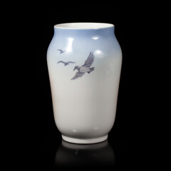 beautiful blue vase depicting a landscape on a black isolated background. antique porcelain vase with painting. village landscape