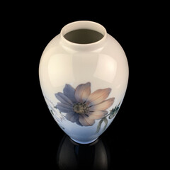 beautiful blue vase with a flower pattern on a black isolated background. antique porcelain vase with painting