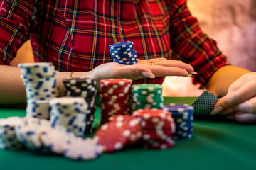 hands of a young Caucasian woman with a beautiful manicure at the casino table close-up.