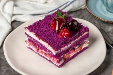 Forest fruit cake slice on dark background. Strawberry, blackberry and raspberry, black mulberry cake. Bakery products. close up