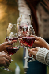 Woman giving a speech to friends at an outdoor party. Young people celebrate a special occasion in a garden restaurant.