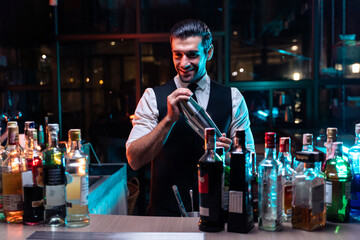 Caucasian profession bartender making a cocktail for customer at a bar. 