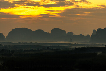 The view of the natural background of the mountain close-up, with blurred fog scattered in the rainy season or the humid climate, with beautiful green trees in the ecological system