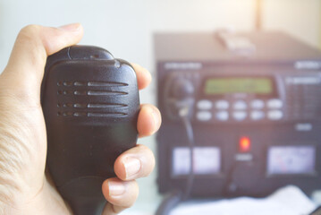 Close up of hand Amateur holding speaker in base station..