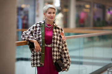 Mature woman fashion style. Portrait female model in fashionable clothes and accessories standing...