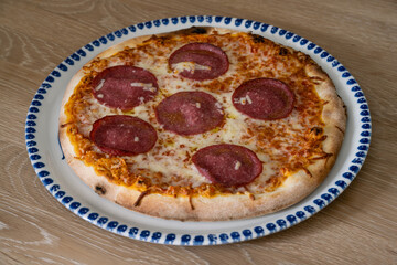 Salami Pizza Italian Style on a Round Plate