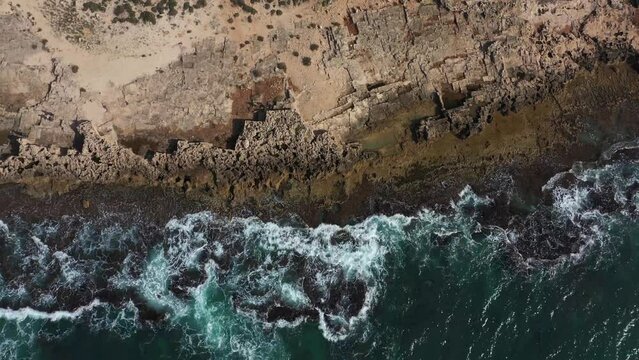 Aerial view of a beach in Israel and a wave with rocks 