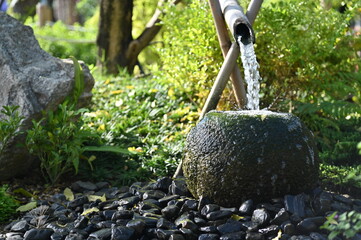 stone in a garden and waterfall