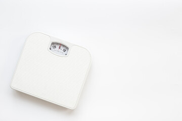 White weight scales on the floor. Weight measurement and loss concept