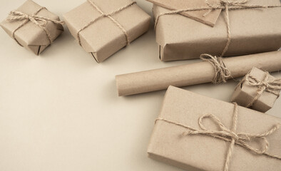 Gift box wrapped in kraft paper on a light background. Holiday concept. Valentine's Day. Place for text or advertising. Present.