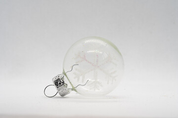 durchsichtige Christbaumkugel mit einer Schneeflocke für den Weihnachtsbaum mit weißen Hintergrund