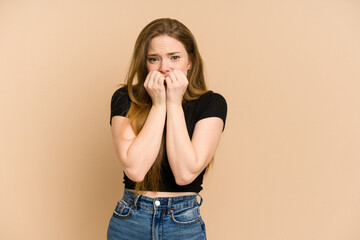 Young redhead woman cut out isolated biting fingernails, nervous and very anxious.