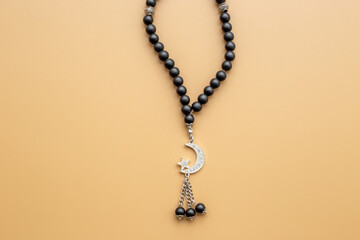 Islamic background with Muslim rosary and silver crescent moon