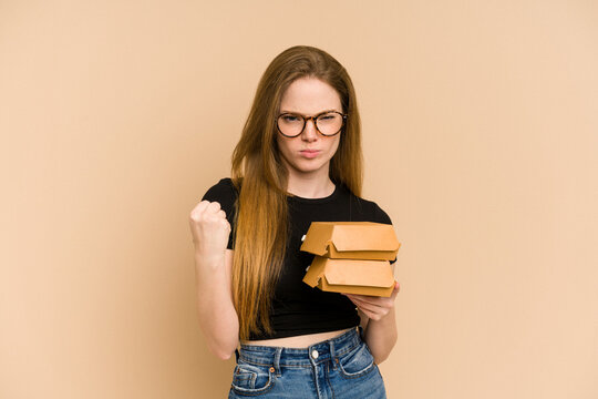 Young Redhead Woman Holding Burgers Cut Out Isolated