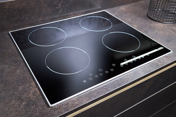 Grey countertop with black glossy built in ceramic glass induction or electric hob stove cooker...