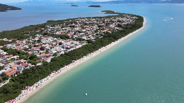 Aerial drone hight scene of houses on the beach seen from above high standard houses facing the sea in florianopolis daniela beach with turquoise blue sea and lots of nature