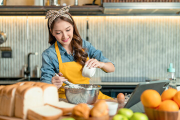 Asian Female Chef learn how to bake bread. Online Video Class, Streaming Service of e-Learning Video Course.bread Recipe Preparation study from tablet online social media course in kitchen at home