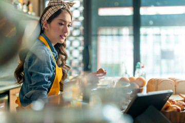 Asian Female Chef learn how to bake bread. Online Video Class, Streaming Service of e-Learning Video Course.bread Recipe Preparation study from tablet online social media course in kitchen at home