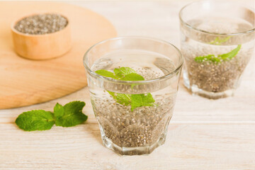 Healthy breakfast or morning with chia seeds and mint on table background, vegetarian food, diet and health concept. Chia pudding with and mint