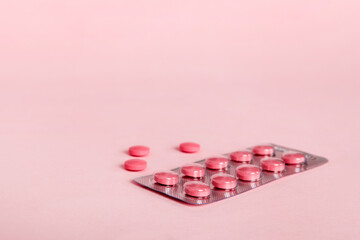 Blister package with Vitamin on color background. Medicine pills on a light background. Medicines and prescription pills flat lay background. pink medical tablets in blister