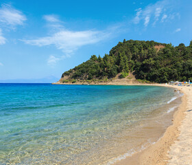 Fototapeta na wymiar Aegean sea coast landscape, view from sandy beach (Chalkidiki, Greece). Peoples unrecognizable.