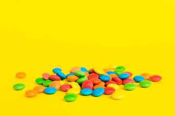 Pile of delicious colorful sweet candies on colored background top view. Confectionery decor